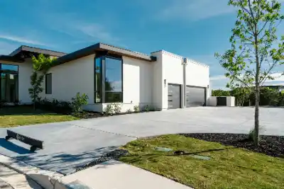 Concrete driveway outside modern white house with large windows | Charleston Concrete