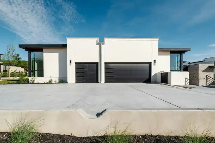 Concrete driveways outside two contemporary white homes | Charleston Concrete