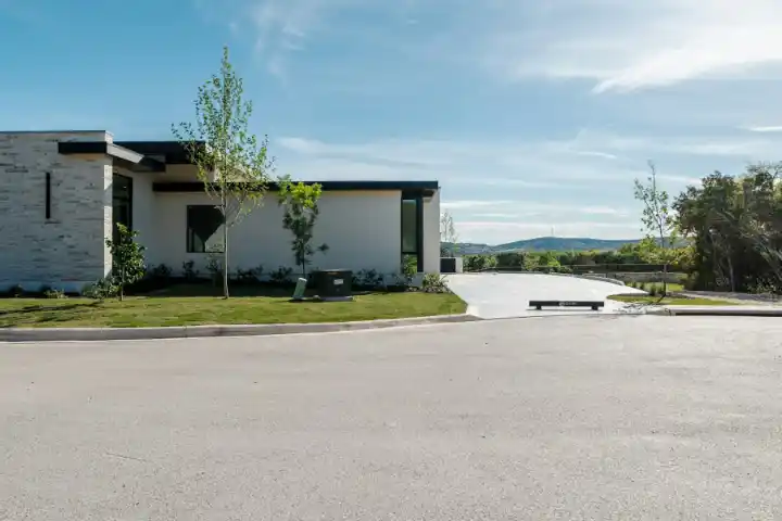 Modern house beside green lawn and concrete driveway | Charleston Concrete