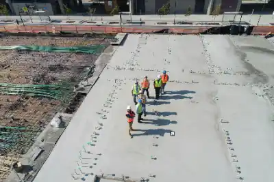 Seven people standing together on rooftop | Charleston Concrete